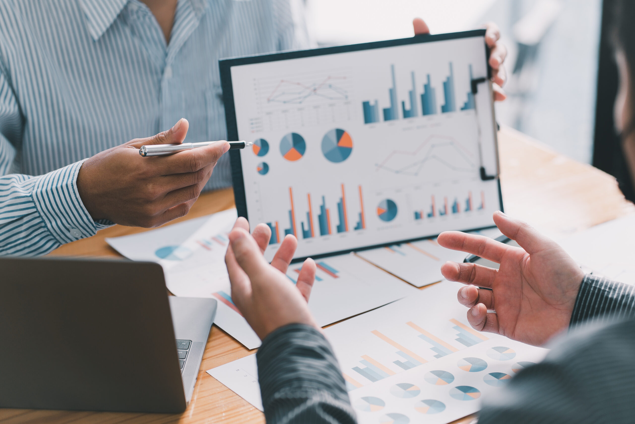 Consultants analyzing results from a market research using data.