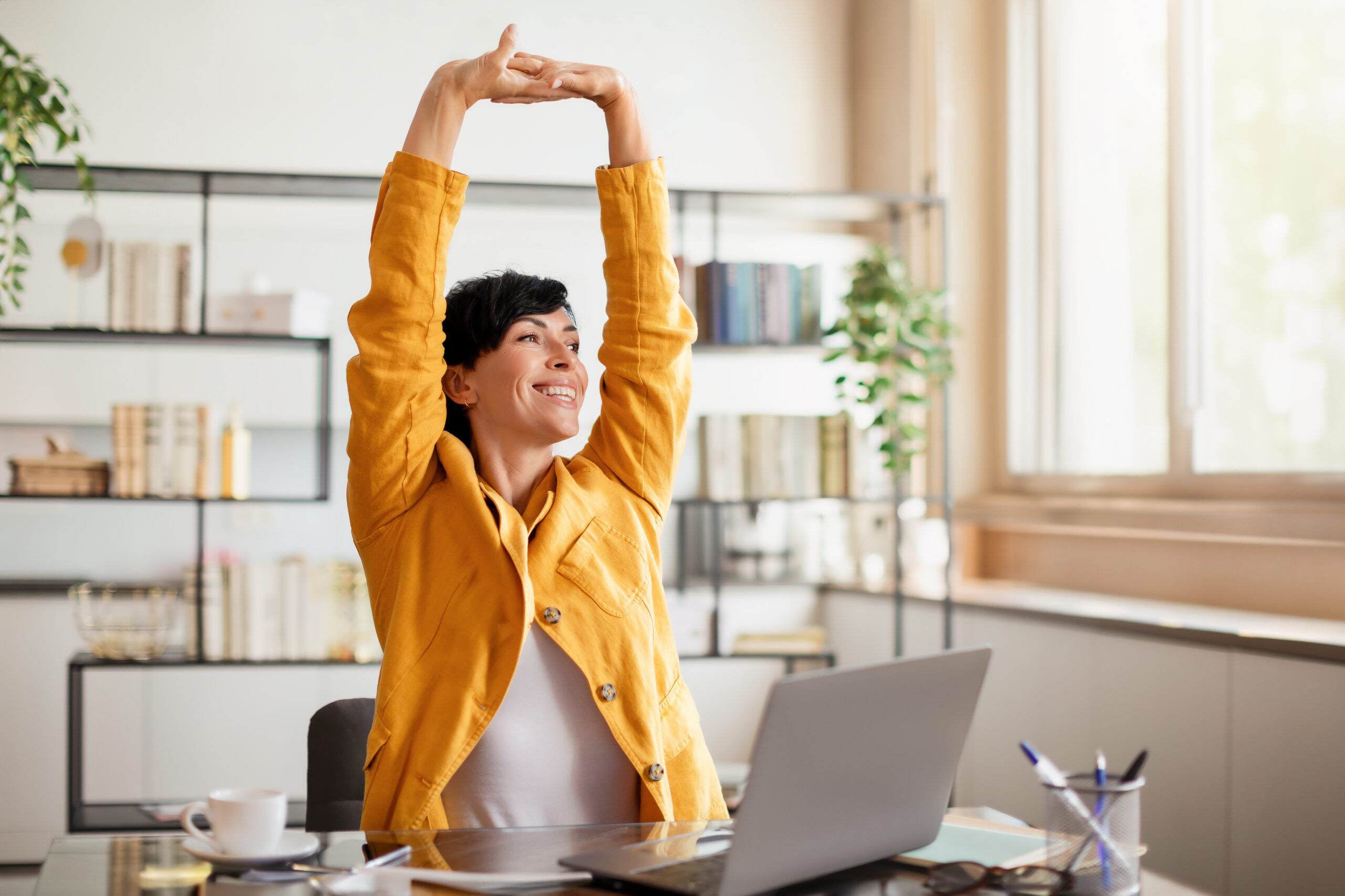 An employee with healthy working habits stretching.